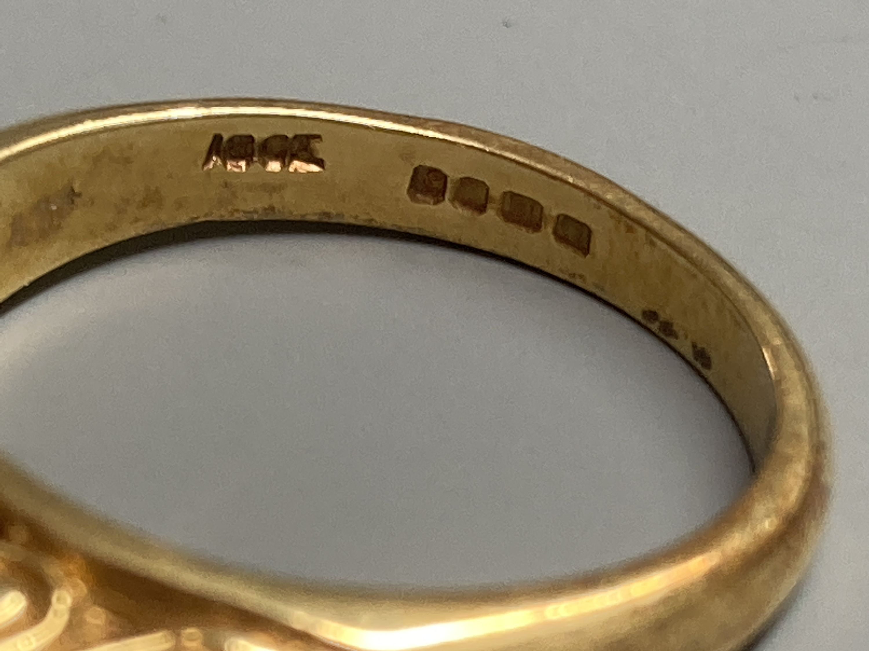 A modern Victorian style 18ct gold, three stone ruby and two diamond set half hoop ring, size N, gross 6.2 grams.
